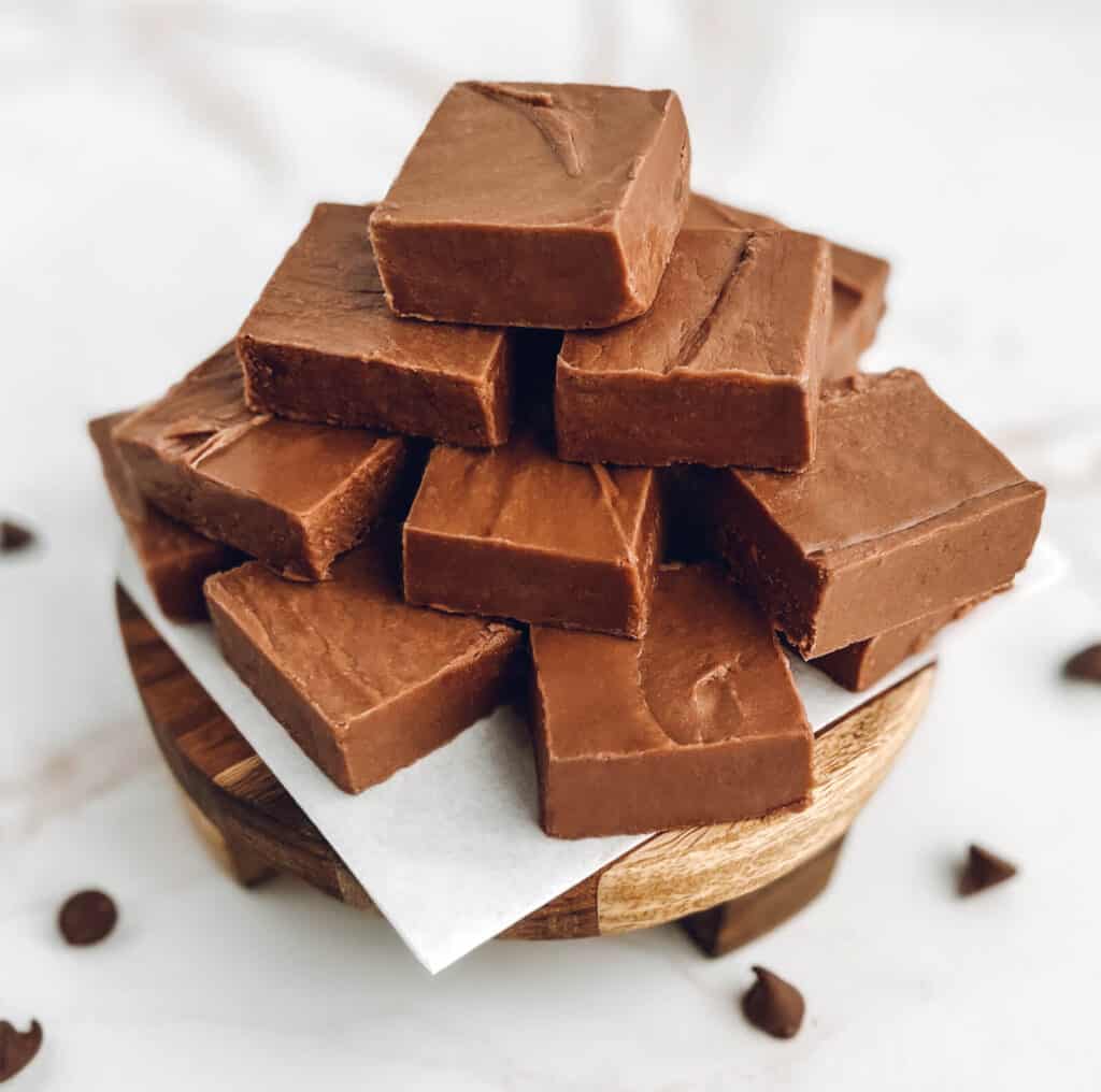 Chocolate Fudge Stacked on Parchment and Wooden Platter
