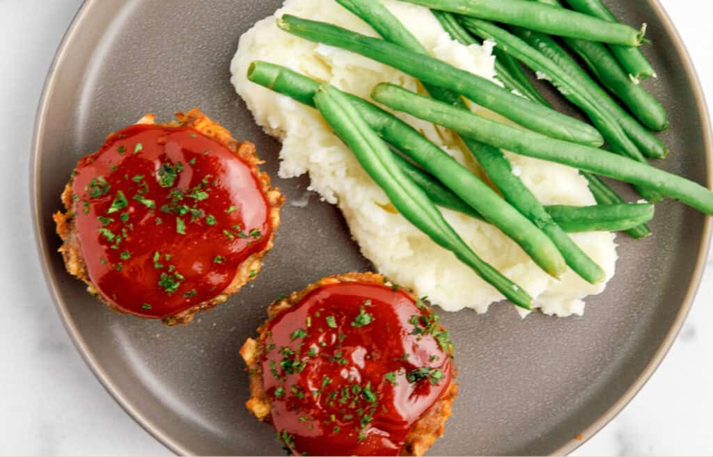 Mini Meatloaves on Grey Plate with Potatoes and Green Beans Top Down