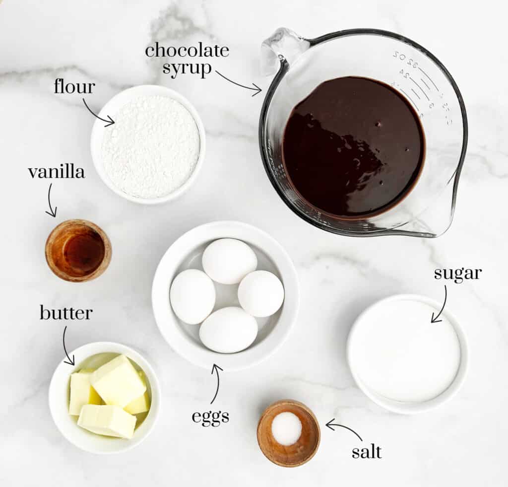 Brownie Layer Ingredients in Bowls on White Marble Surface