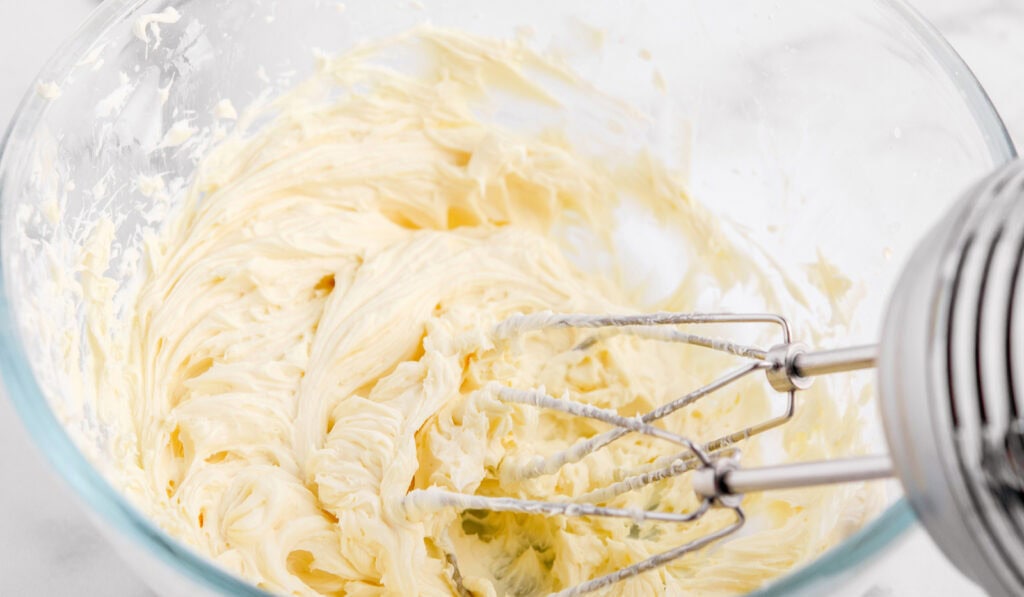 Blending Cream Cheese Filling in Bowl with Electric Mixer