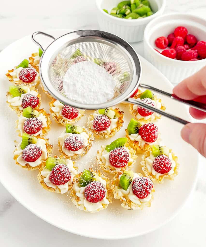 Dusting Cheesecake Bites with Powdered Sugar