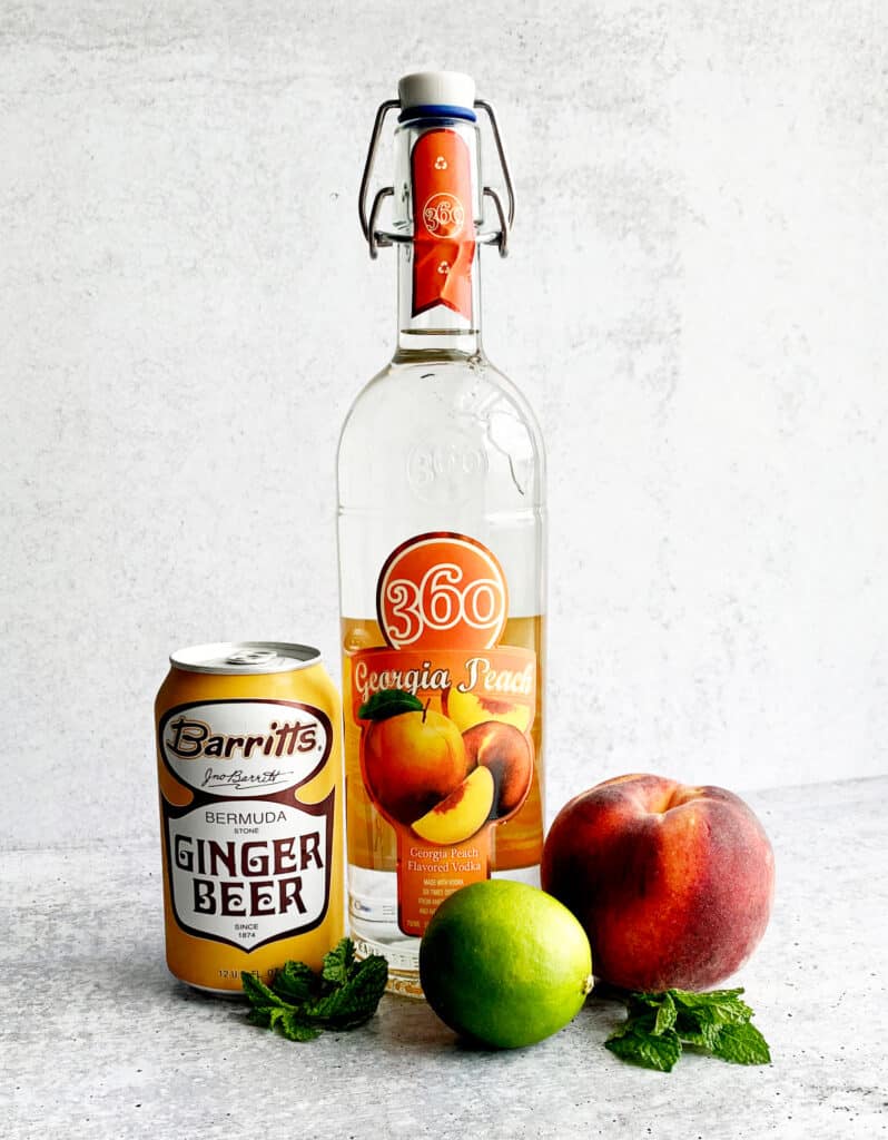 Ginger Beer, Peach Vodka, Lime, Peach on Counter top