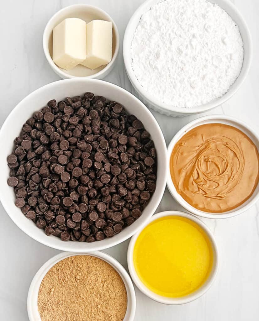 Peanut Butter Cup Ingredients Including Chocolate Chips, Peanut Butter, Butter, Graham Crackers, Powdered Sugar, and Almond Bark