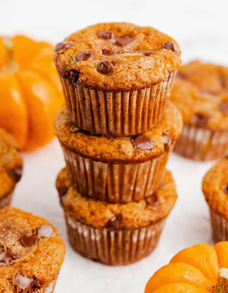 Pumpkin Chocolate Chip Muffins Stacked with Mini Pumpkins
