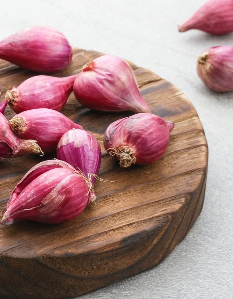 Shallots pm a Wooden Cutting Board