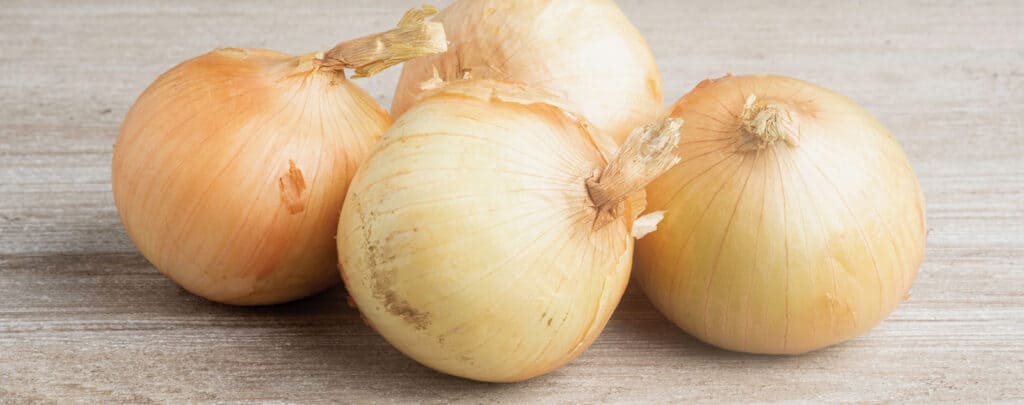 Sweet Onions on a Wooden Surface