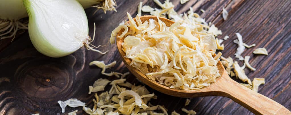 Dried Onion in a Spoon on a Dark Countertop