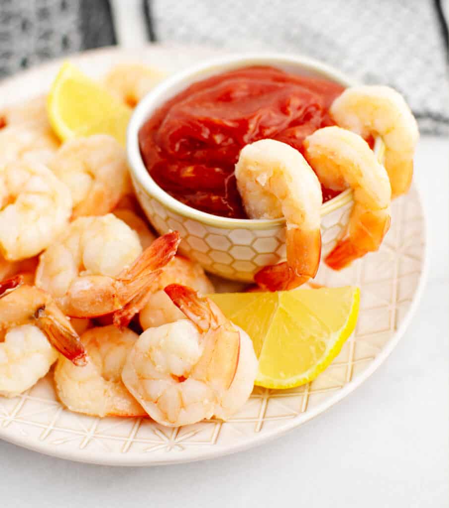 Shrimp Cocktail Closeup with Cocktail Sauce, Shrimp, and Lemon on Plate