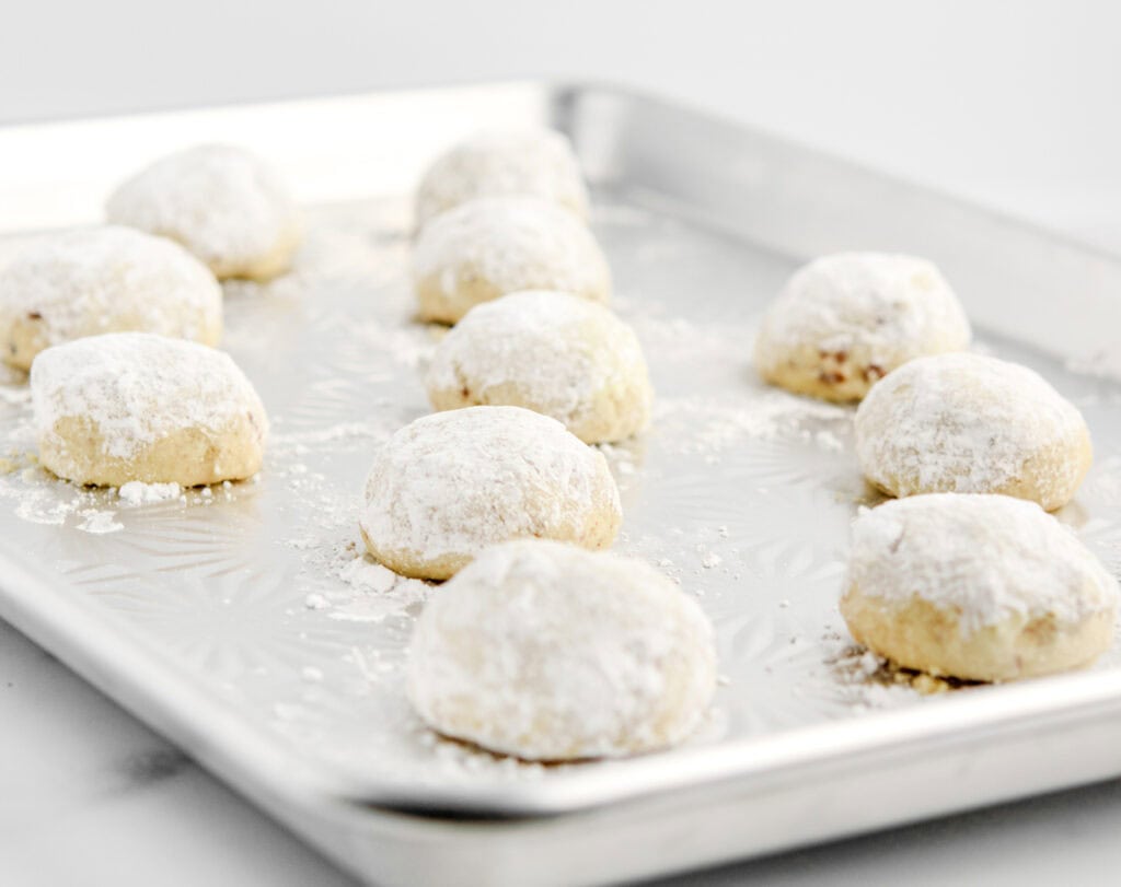 Snowball Cookies Dusted in Powdered Sugar on Baking Pan