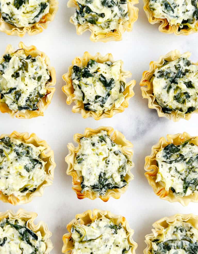 Spinach Artichoke Bites on White Surface