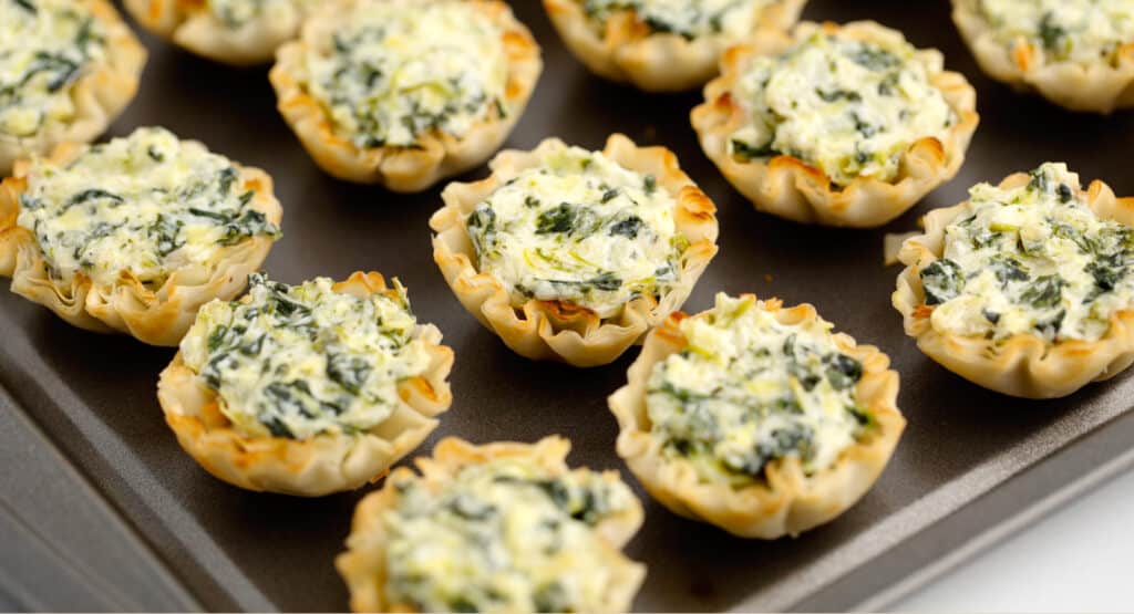 Spinach Artichoke Bites on Dark Surface