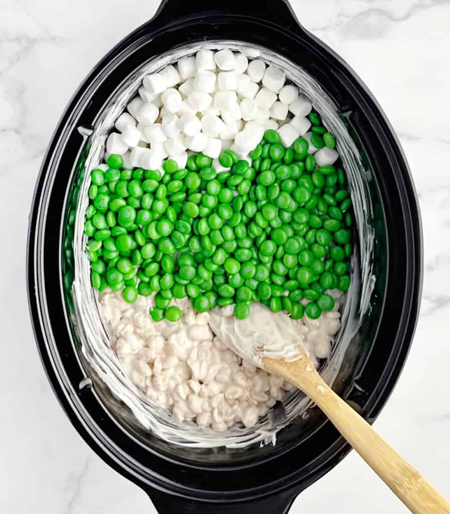 Adding Green M&Ms and Marshmallows to Candy Mixture in Slow Cooker