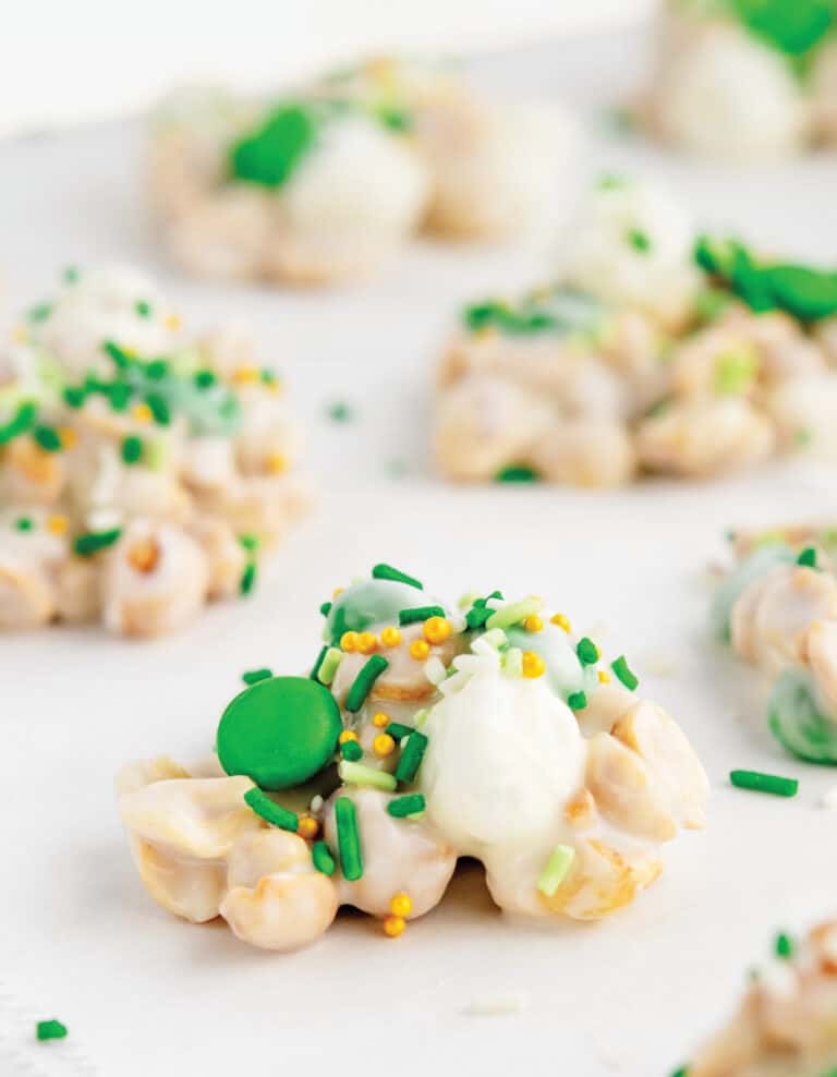 Crockpot Candy with Green M&Ms and sprinkles on parchment paper