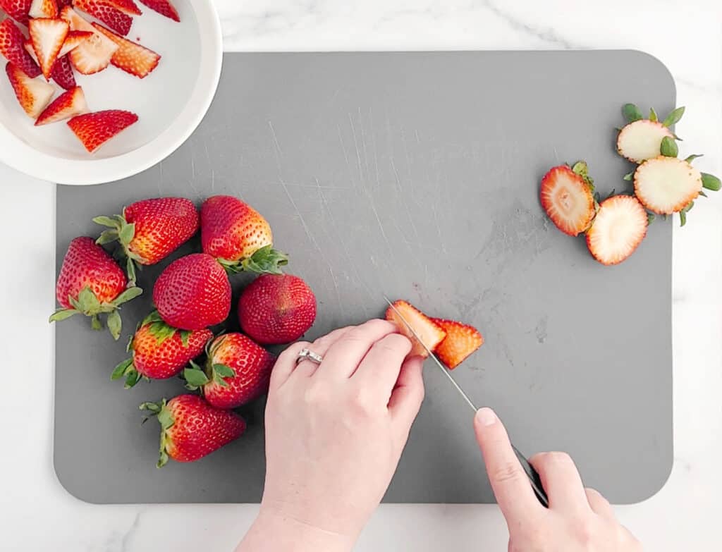 Slicing Strawberries on a Grey Cutting Board