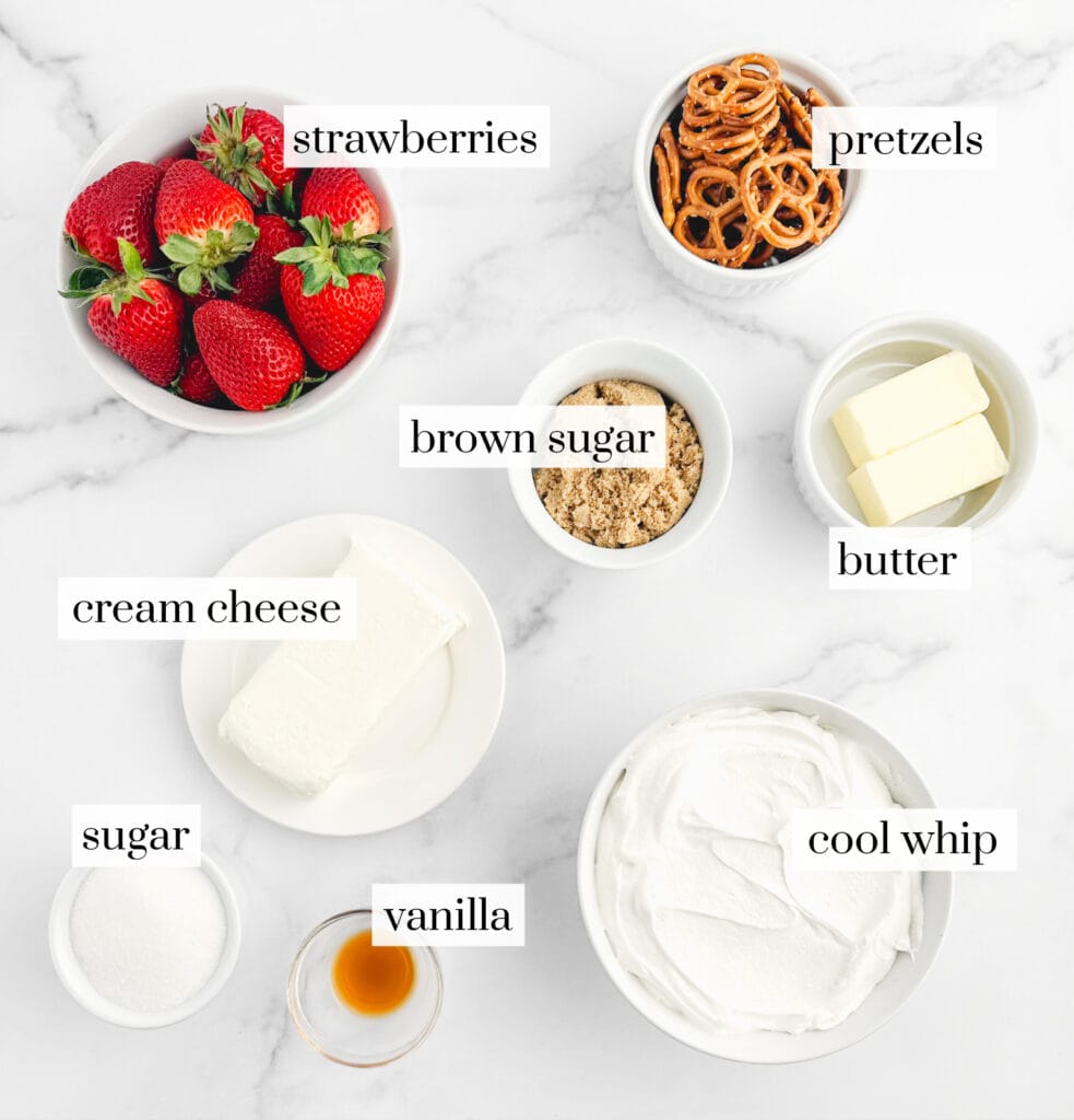 Strawberries, Pretzels, Brown Sugar, Butter, Cream Cheese, Sugar, Vanilla, and Cool Whip in Bowls on Marble Surface