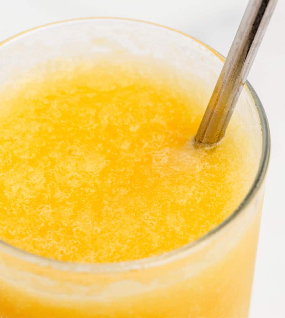 Closeup of Orange Slush in Glass with Straw