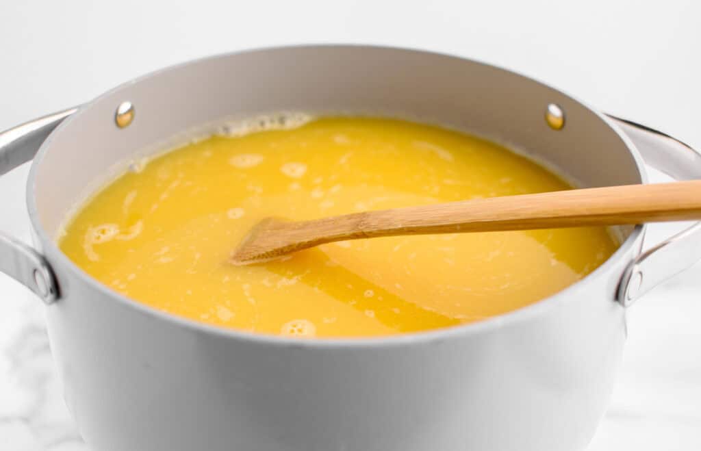 Final Orange Citrus Mixture in Grey Pot with Wooden Spoon
