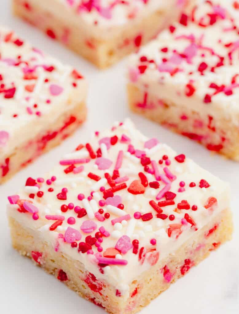Valentine Sugar Cookie Bars Cut in Pieces on Parchment