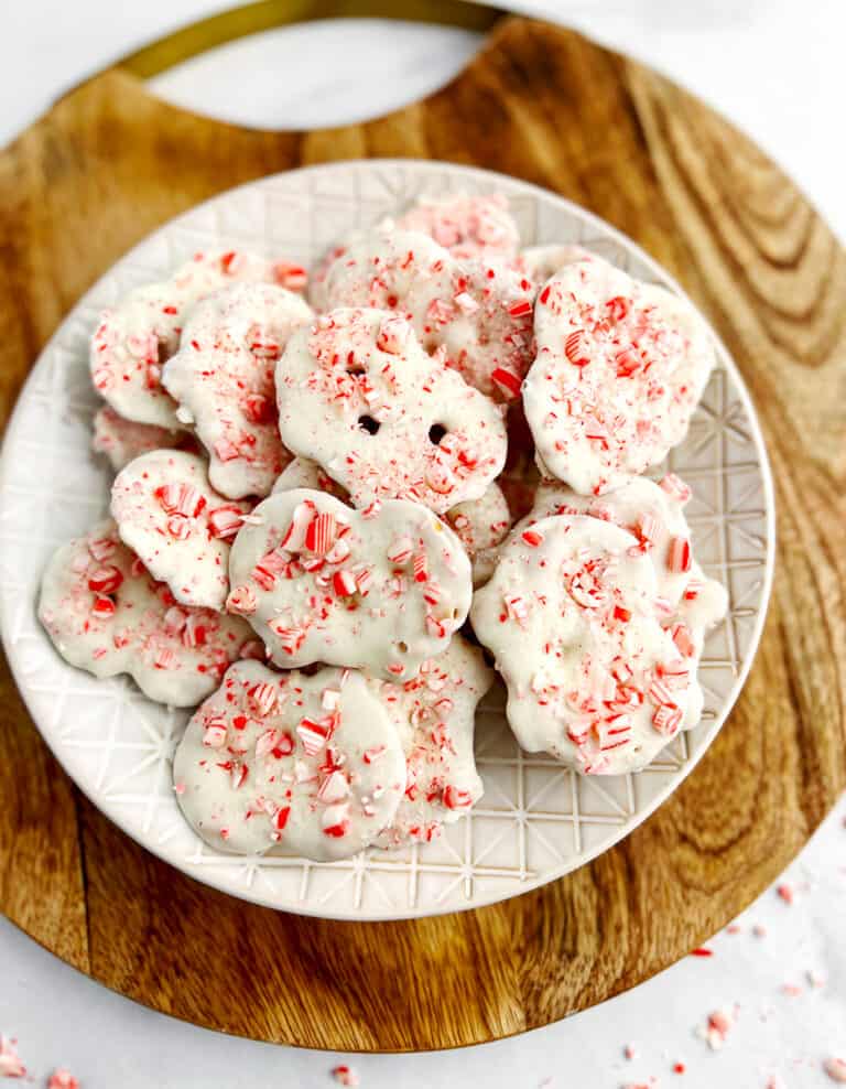 White Chocolate Peppermint Pretzel Crisps on Plate on Wooden Surface